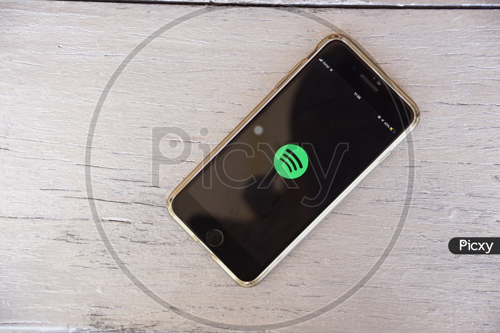Flat lay of smart phone with Spotify app icon on screen