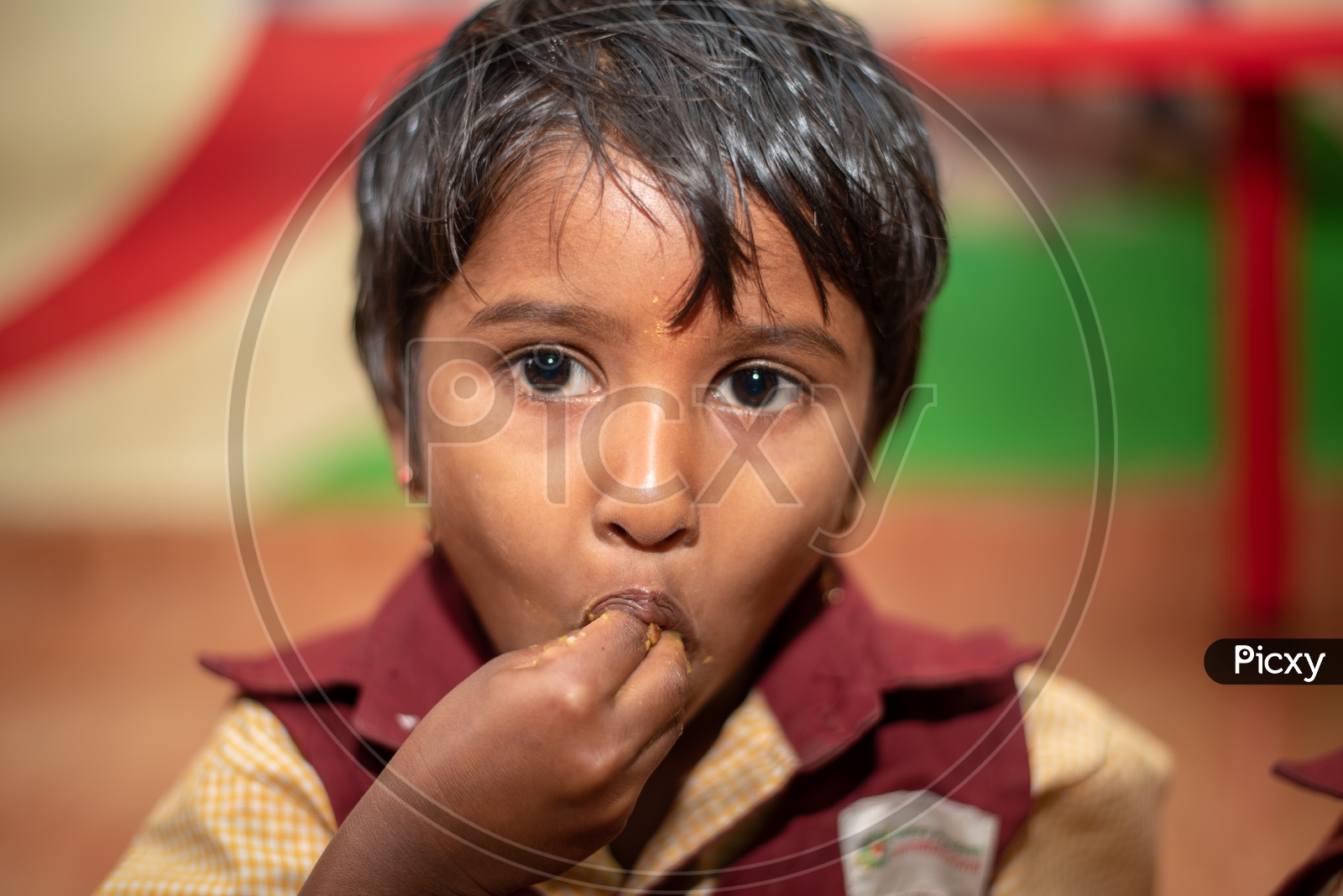 Girl student eating her mid day meal in an Anganwadi center