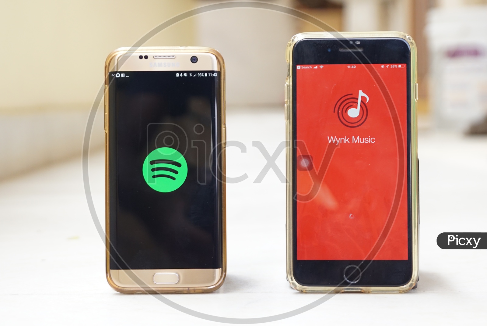 Smartphones with Spotify app and Wynk app on screen