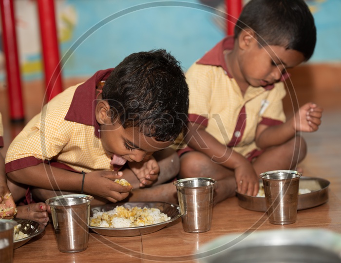 Young boys eating their mid day meal in an Anganwadi centre