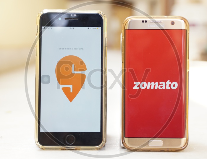 Smartphone with Swiggy  and Zomato applications on Screen
