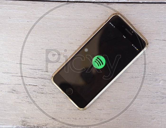 Flat lay of smart phone with Spotify app icon on screen