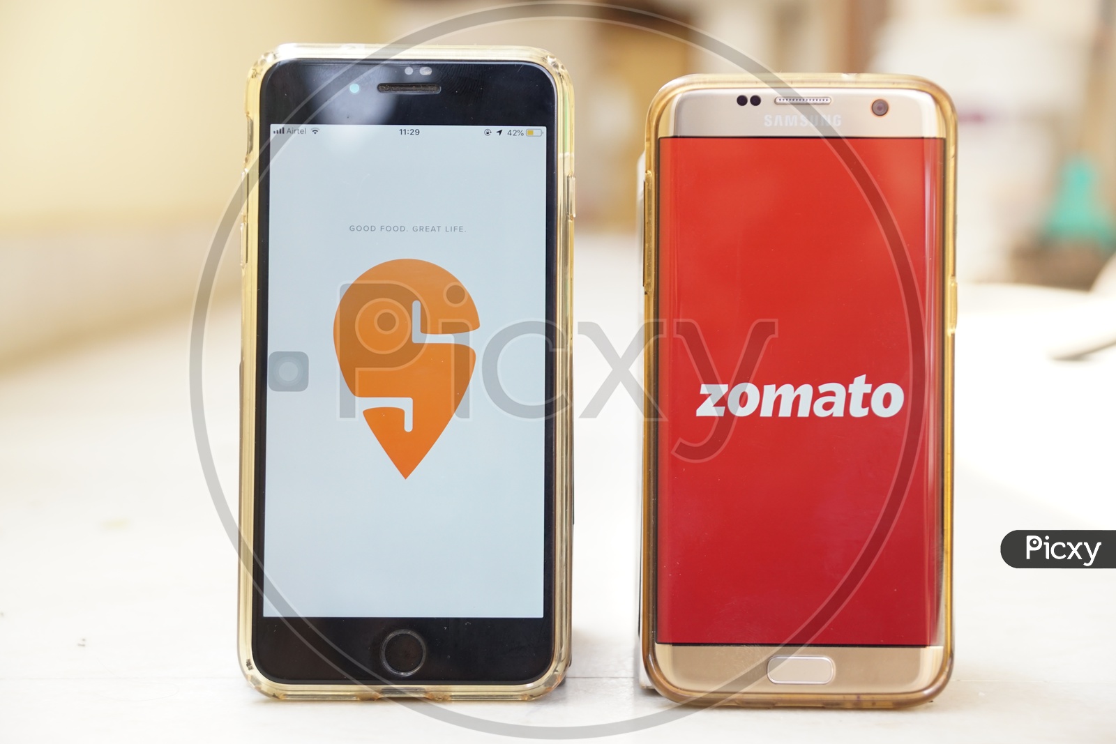 Smartphone with Swiggy  and Zomato applications on Screen