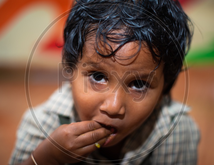 Portrait of a student eating his mid day meal in an Anganwadi center