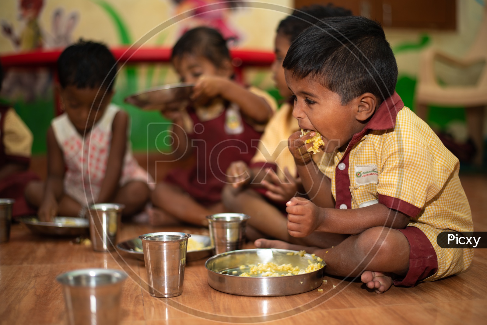 Students eating their mid day meal in an Anganwadi center