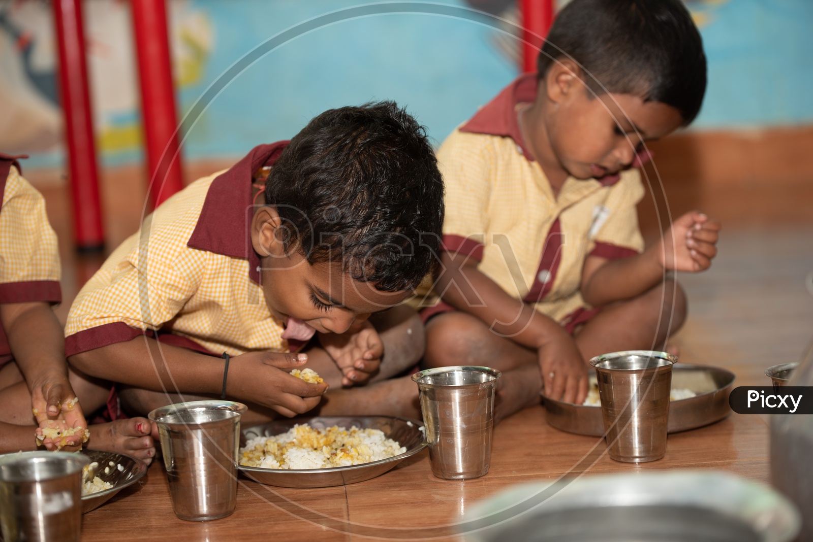 Young boys eating their mid day meal in an Anganwadi centre