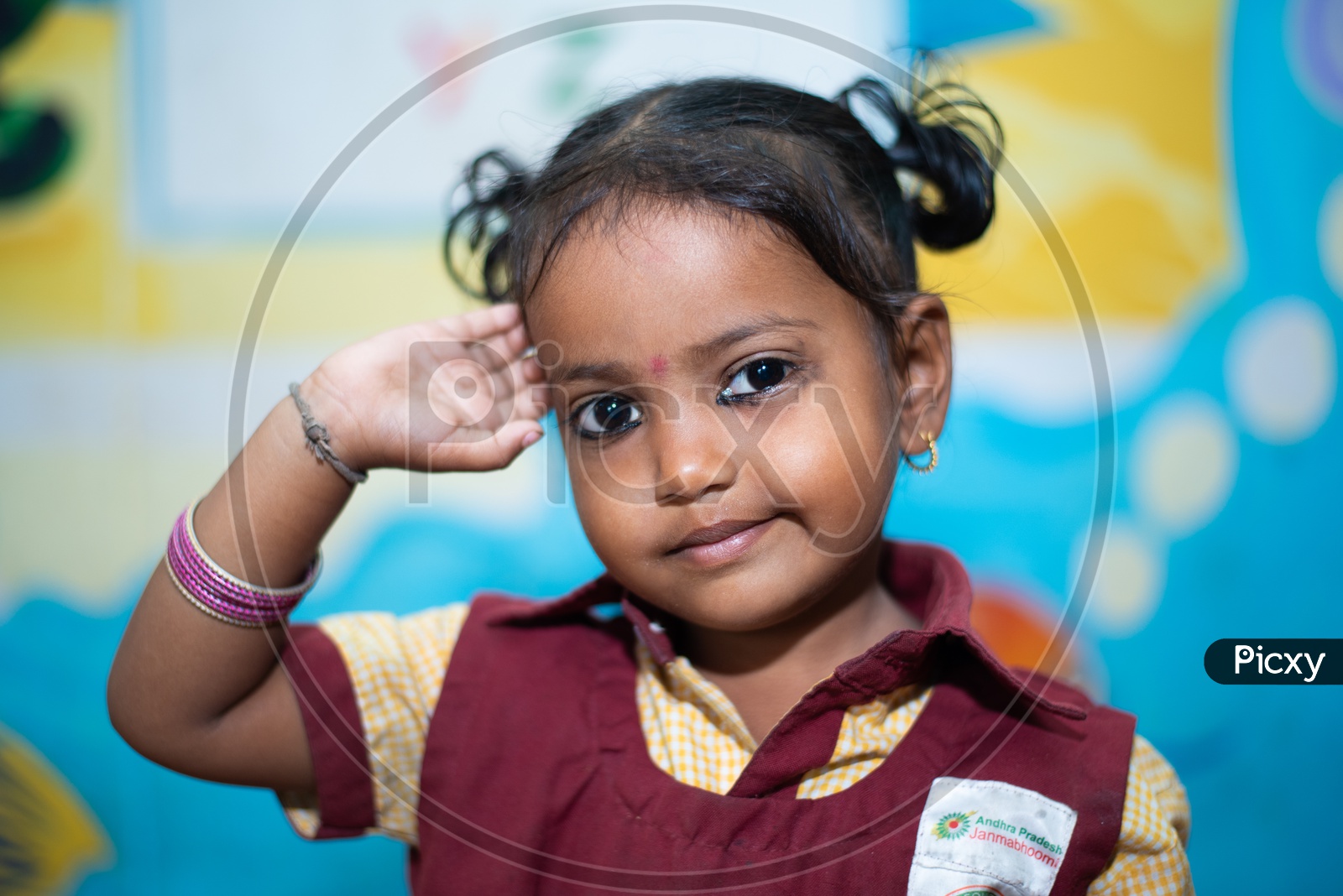 Portrait of a girl student saluting in an Anganwadi centre
