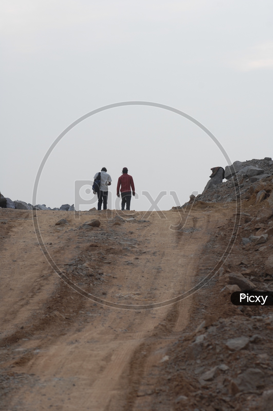 Two men walking along the quarry road