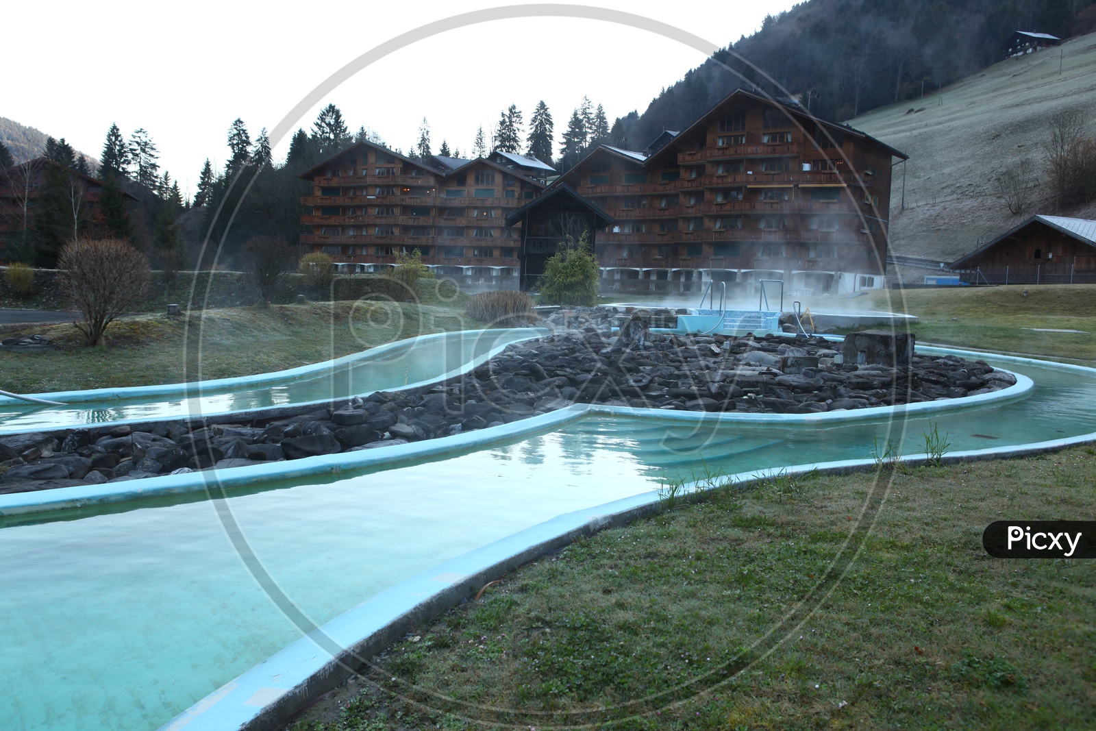 Outdoor Swimming pool with mountain and houses in the background