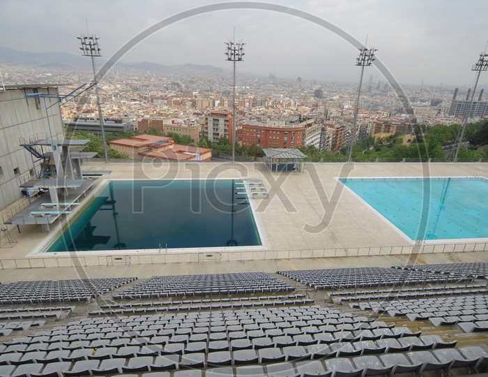 View of audience seating arrangement alongside swimming pool