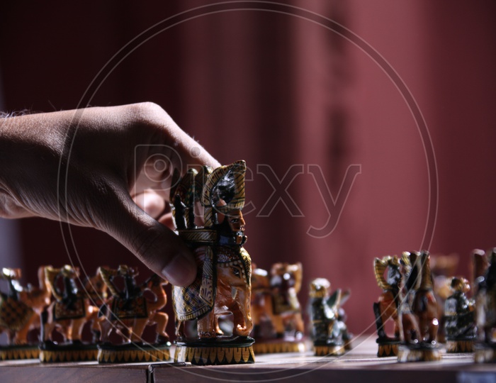 Man moving the chess piece on the board