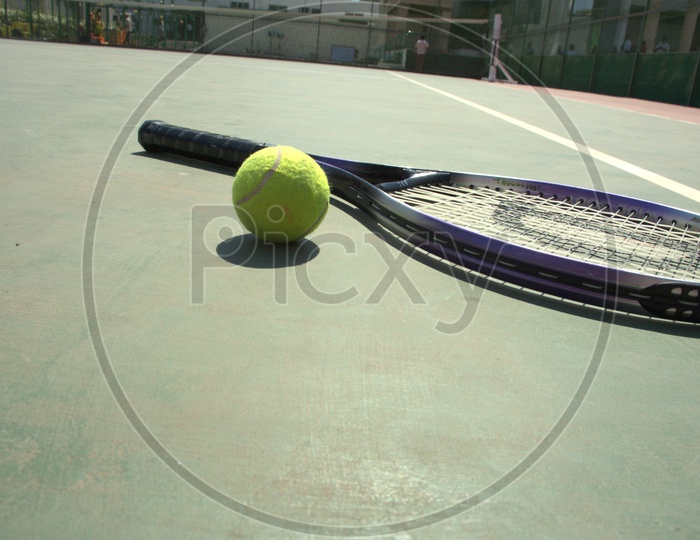 Tennis racket and ball in a court