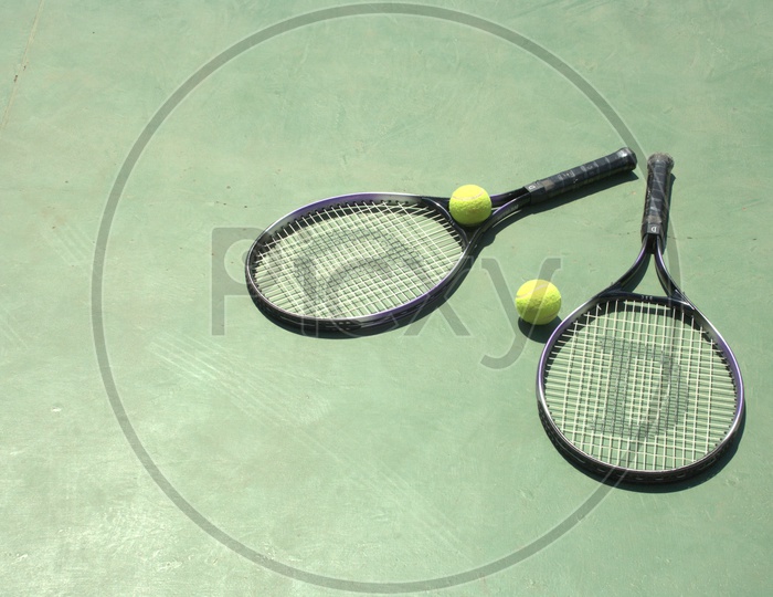 Tennis balls and rackets in a court