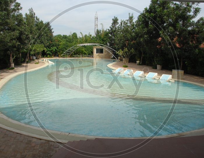 Swimming pool with an arch bridge in between