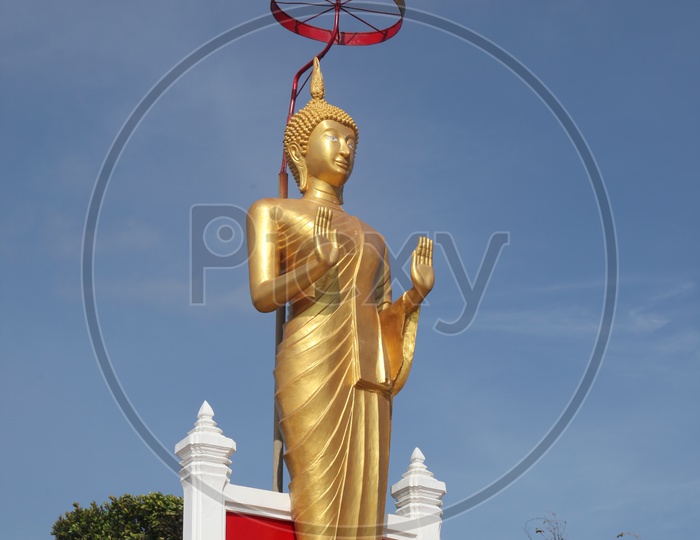 Golden standing Buddha Statue