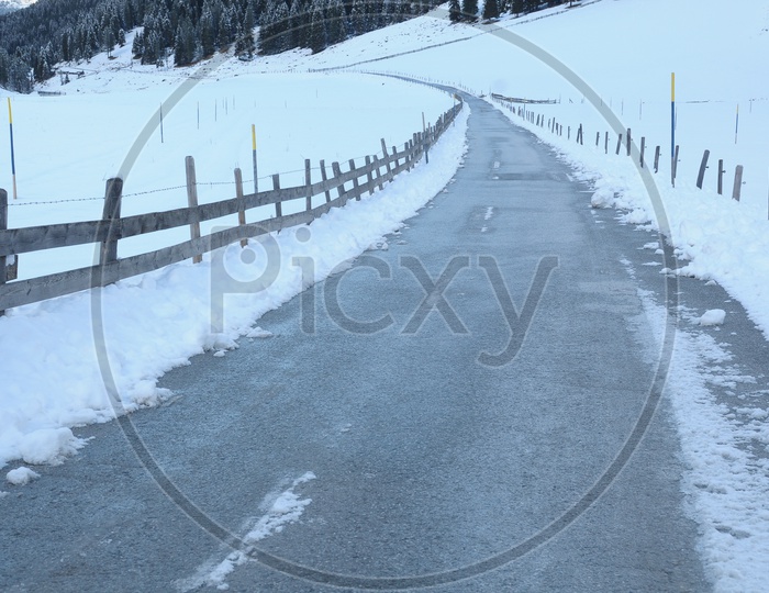 Pathway alongside the snow covered land