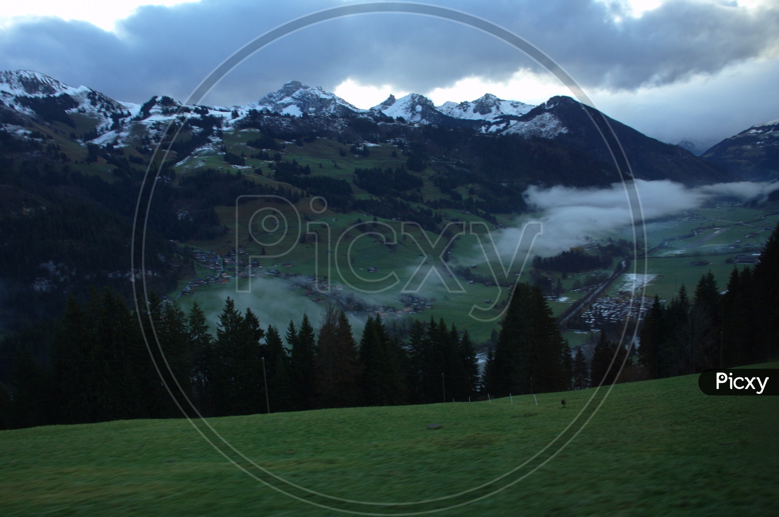 View of Swiss Alps covered with dark clouds