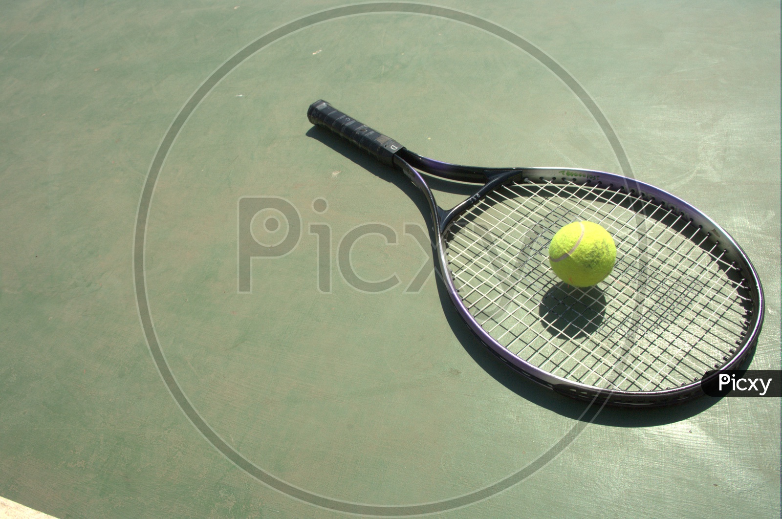 Tennis ball and racket in a court
