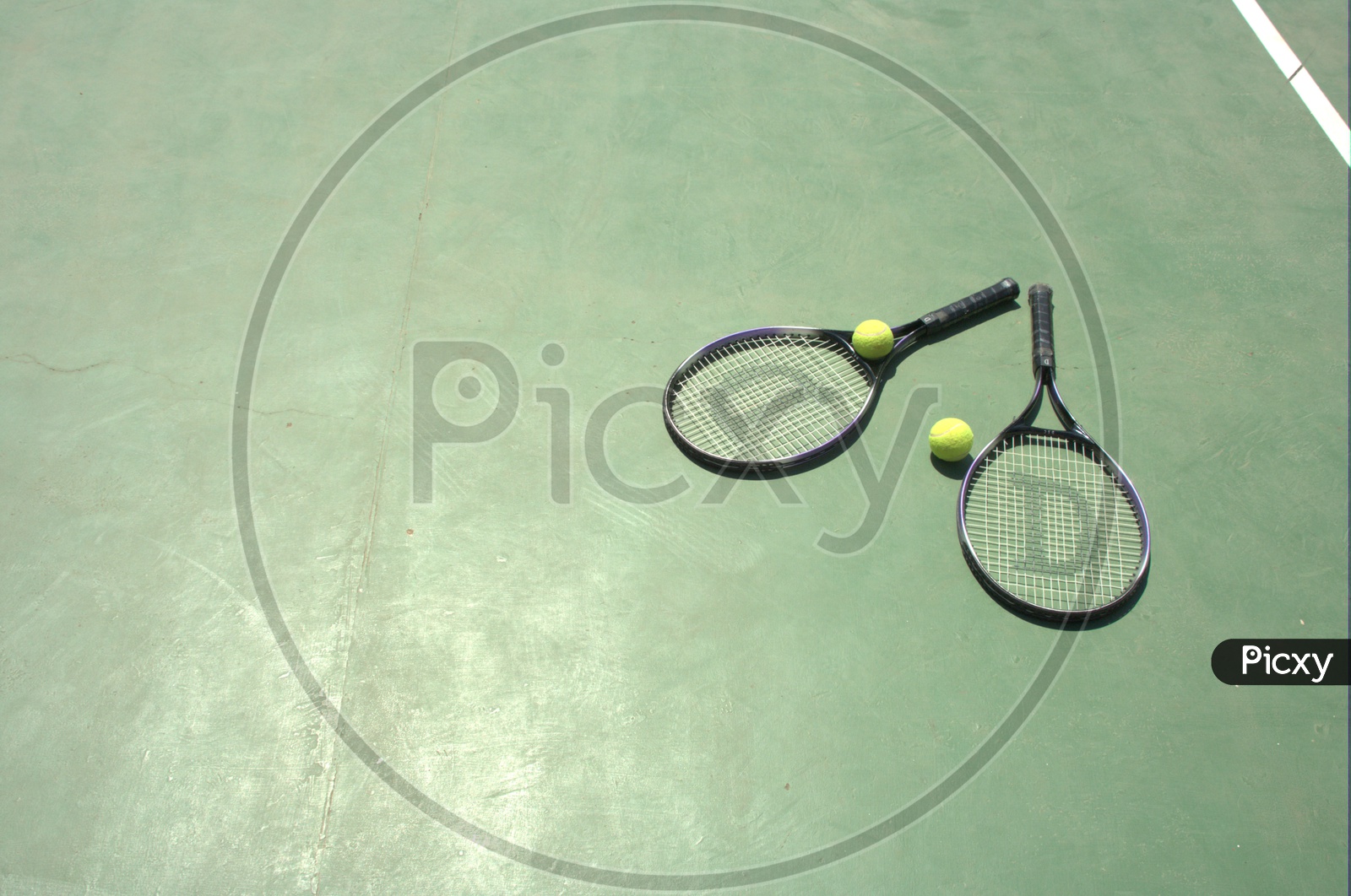 Tennis balls and rackets in a court