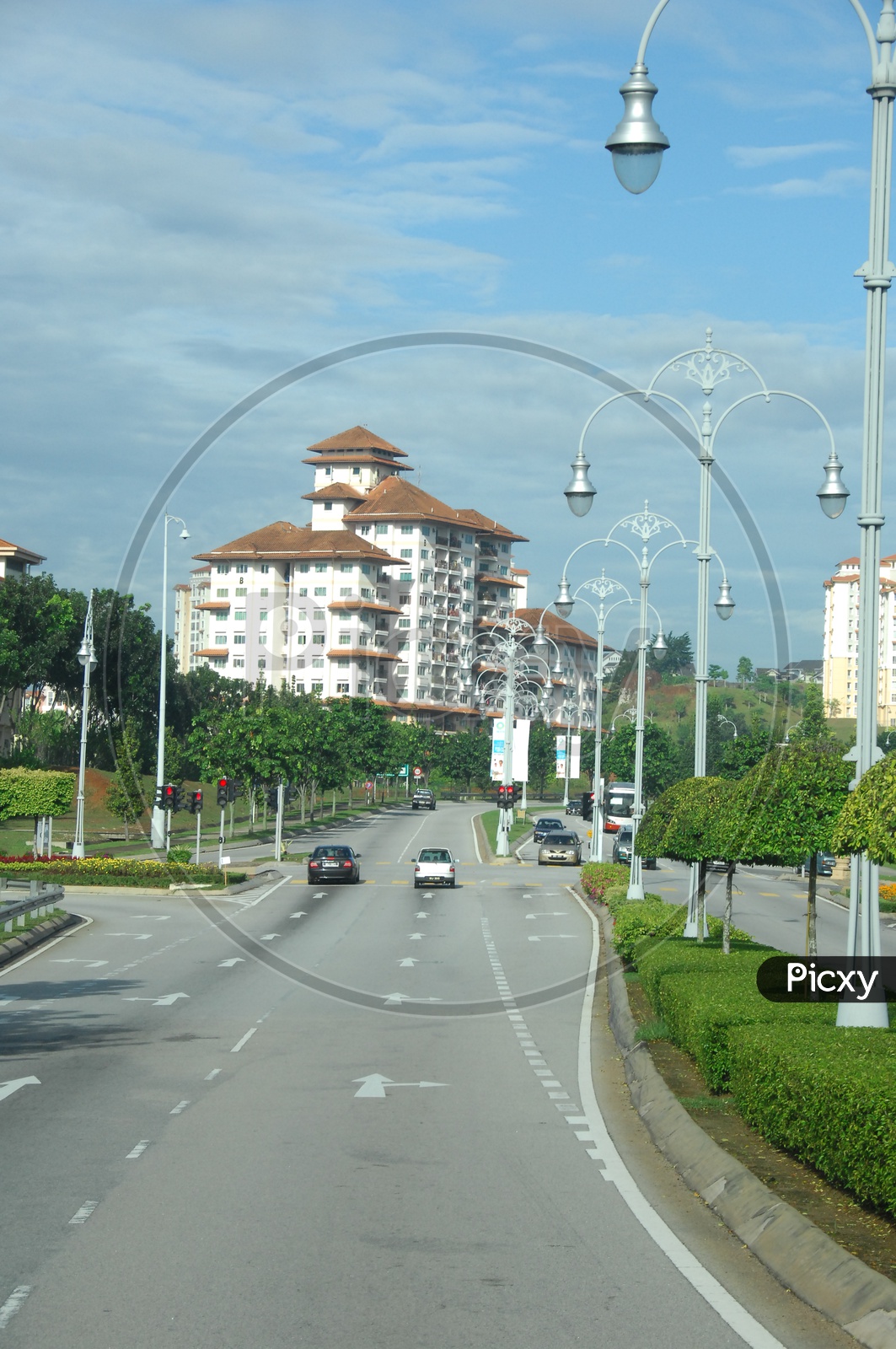 View of street lights and commercial buildings along the road