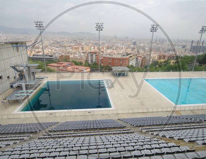 View of audience seating arrangement alongside swimming pool