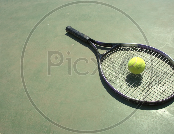 Tennis ball and racket in a court