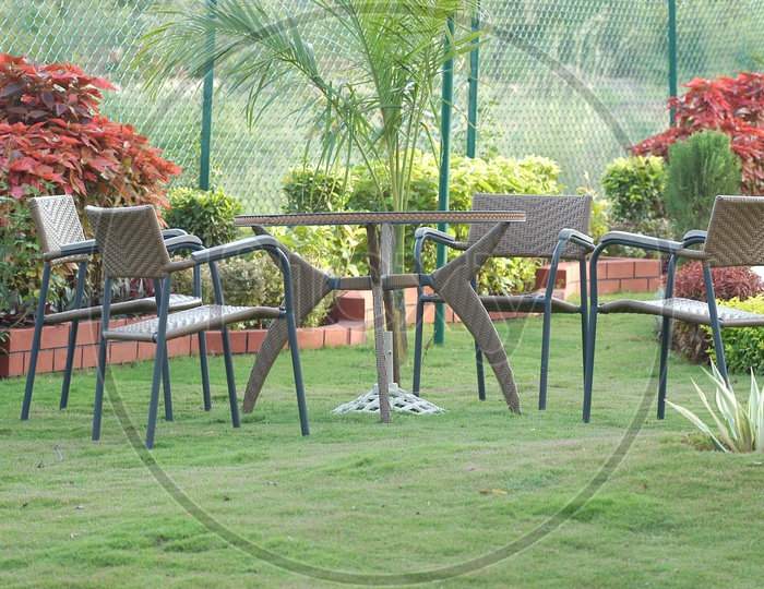 Table And Chairs In a Lawn Garden