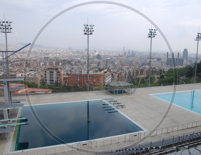 View of swimming pool alongside the city buildings