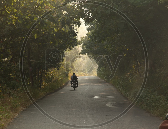 A man riding motorcycle on the road