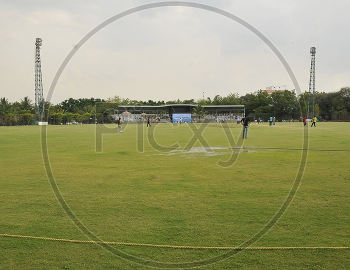 Players having practice session in a cricket ground
