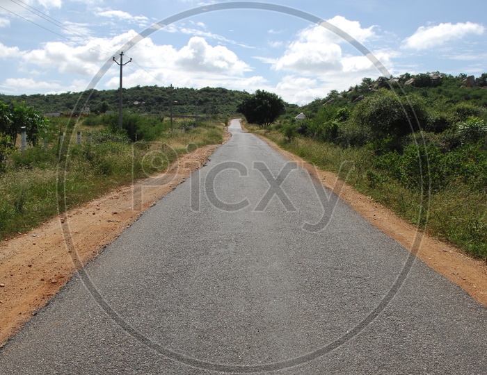 An empty tar road in a rural area