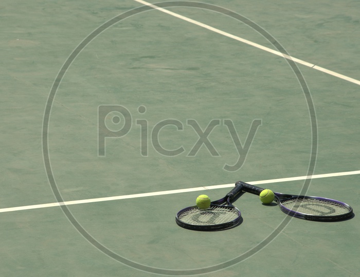 Tennis rackets and balls in a court