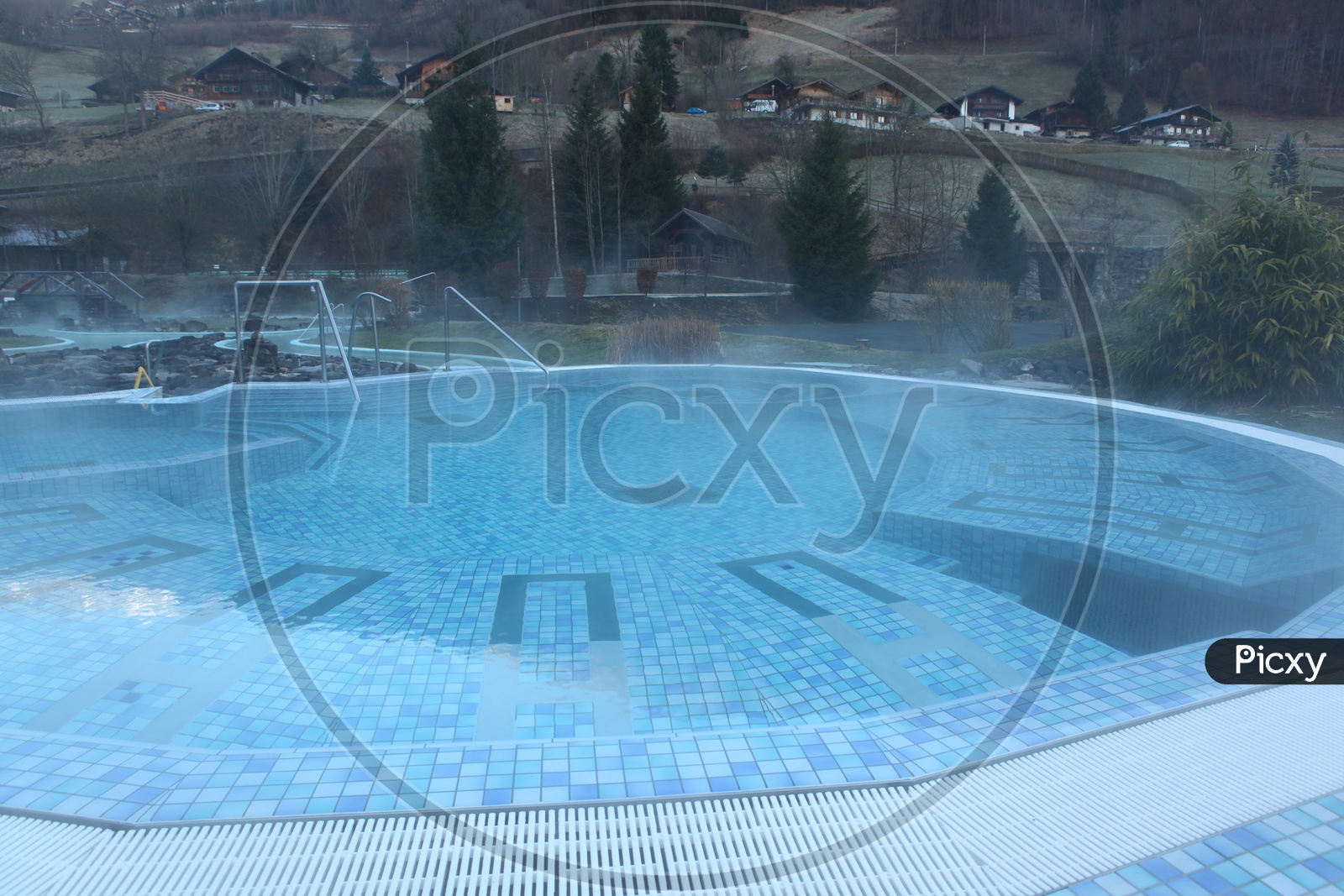 Outdoor Swimming pool with mountain and houses in the background