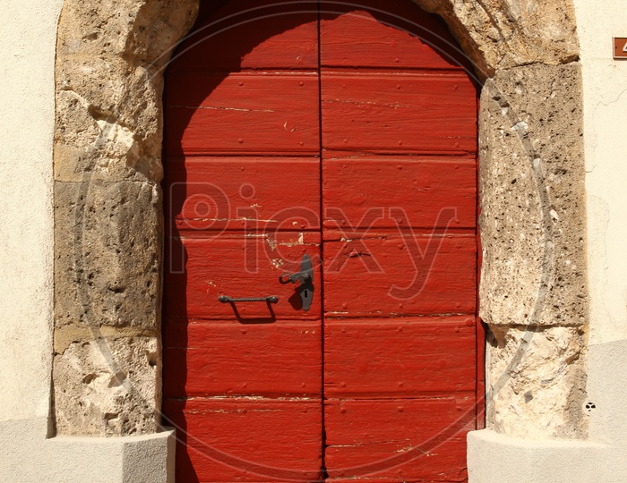 Close up of a red arch door