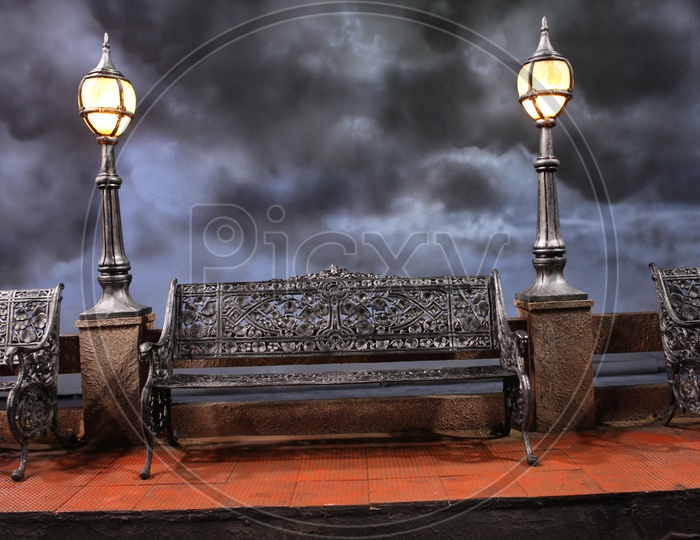Antique sitting bench alongside the lamps