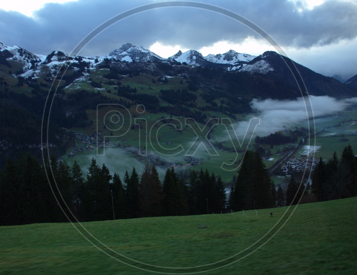 View of Swiss Alps covered with dark clouds