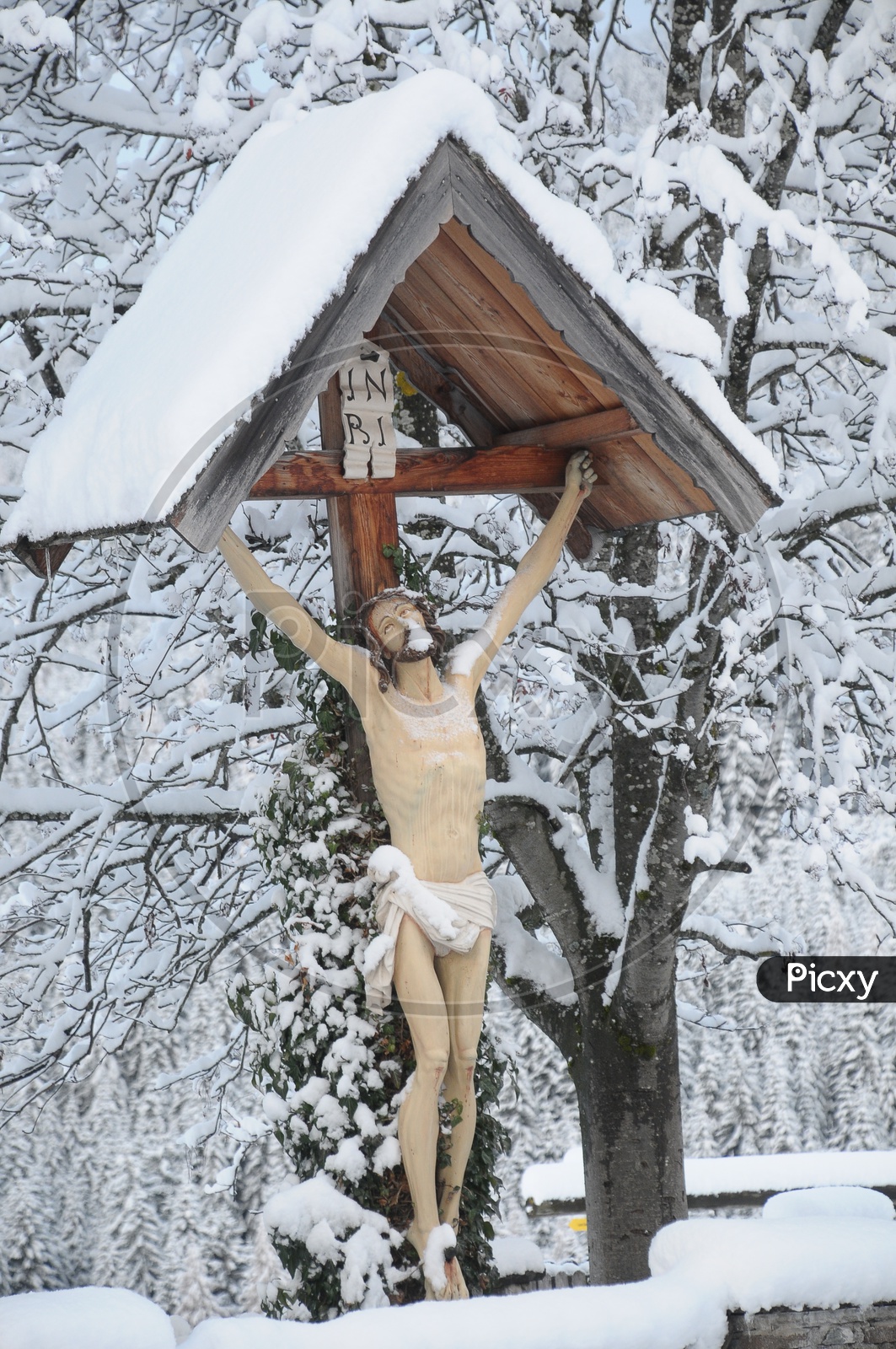 Jesus crucification statue during the snow