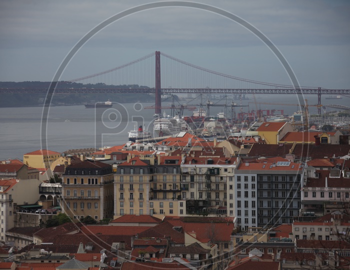 Buildings and Ponte De Abril suspension bridge on the left in Lisbon
