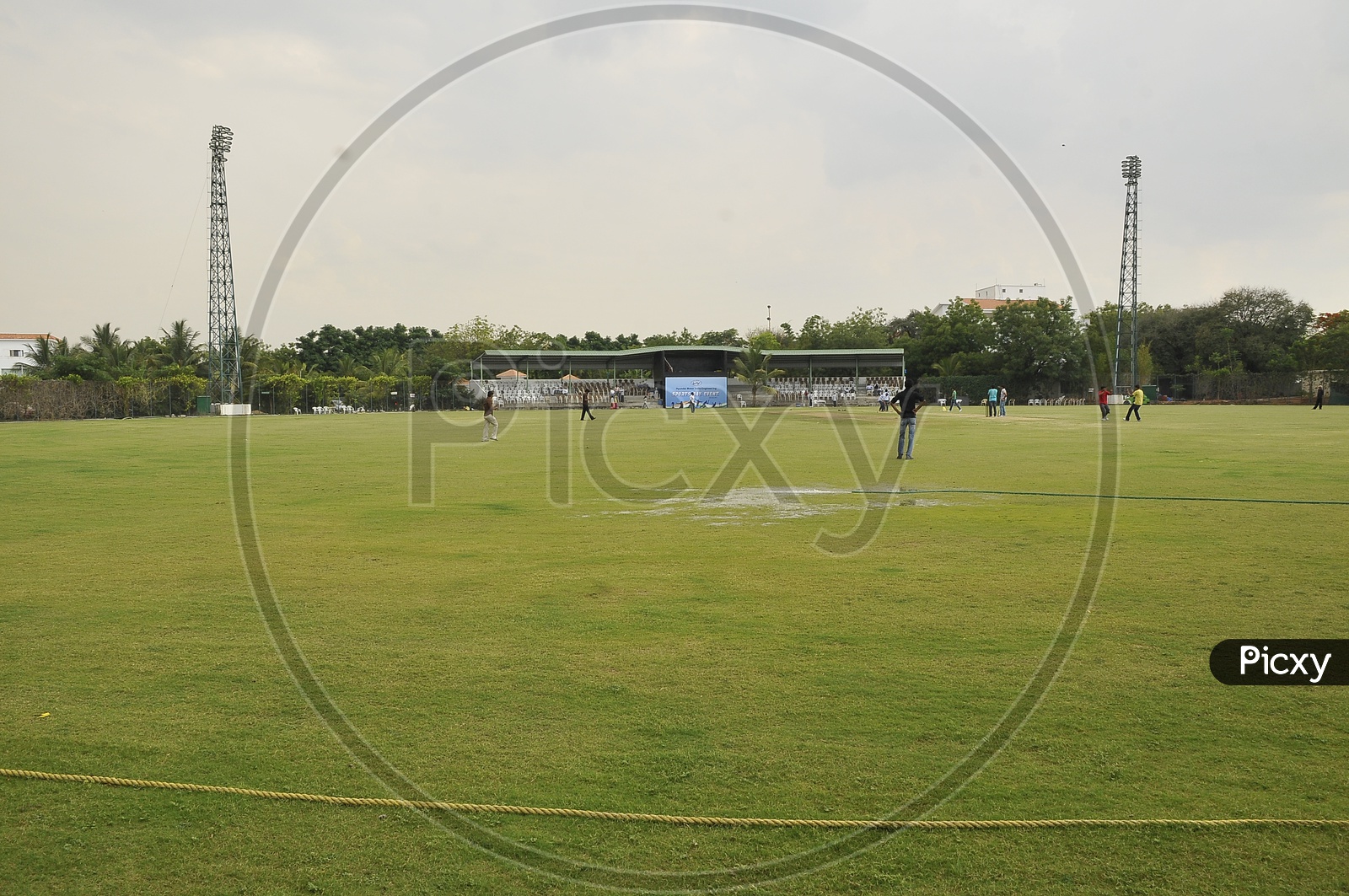 Players having practice session in a cricket ground