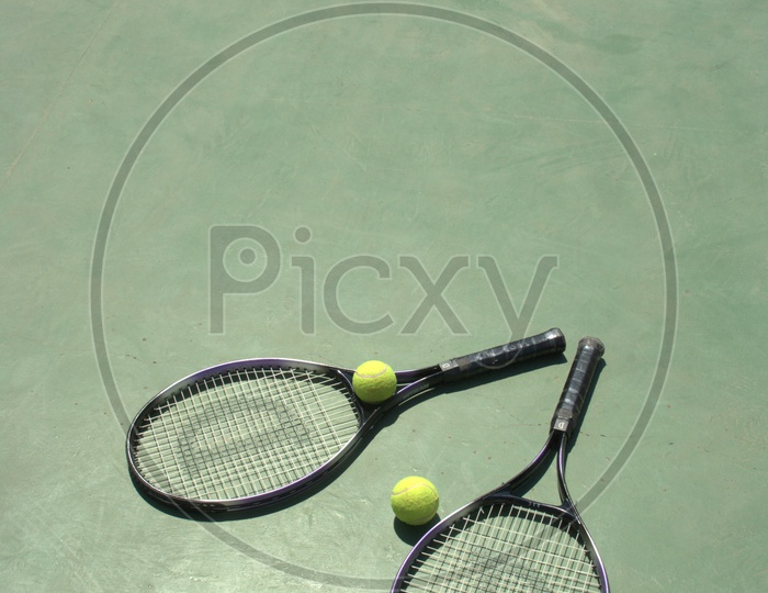 Tennis rackets and balls in a court
