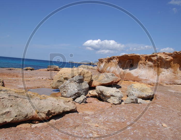 large rocks in a beach and a small cliff