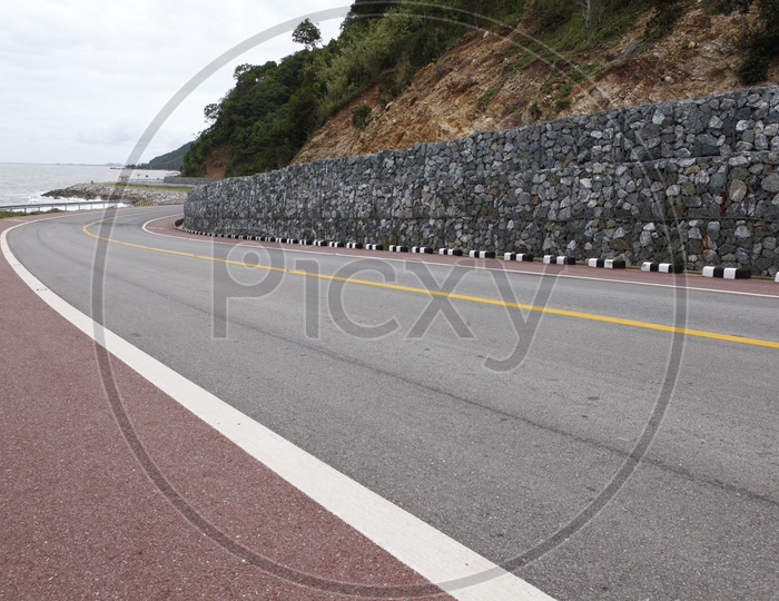 View of rock wall alongside the road curve