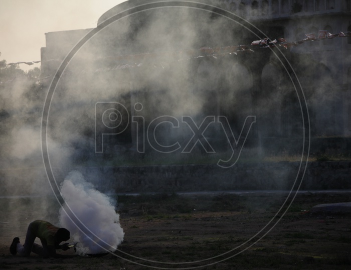 A Person Making Thick Smoke for Movie Shooting