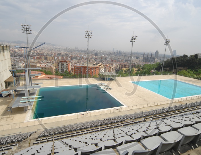 View of swimming pool alongside the city buildings