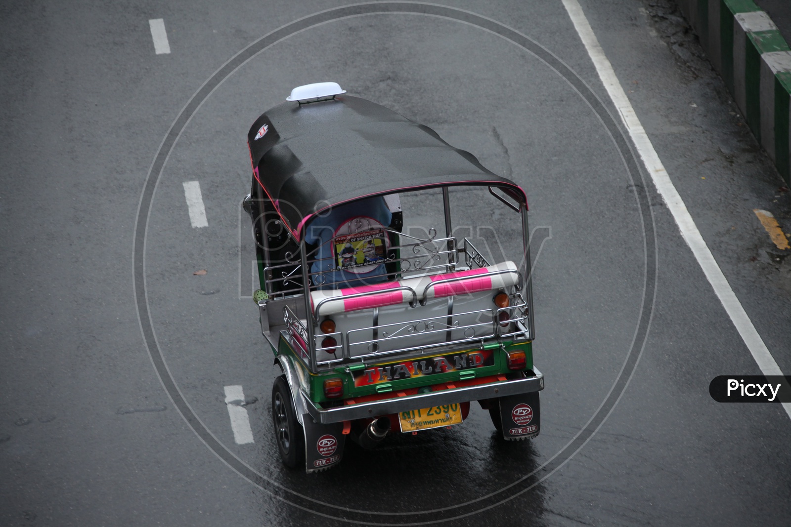 A rickshaw moving on a wet road