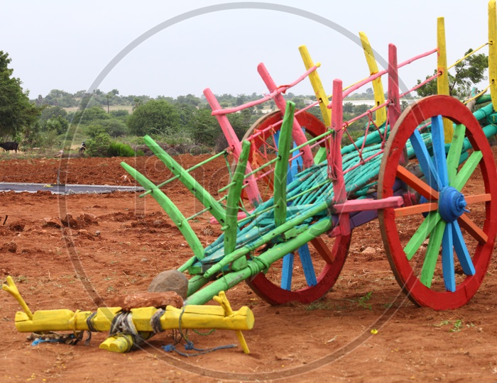 Colourful bullock cart alongside the mud