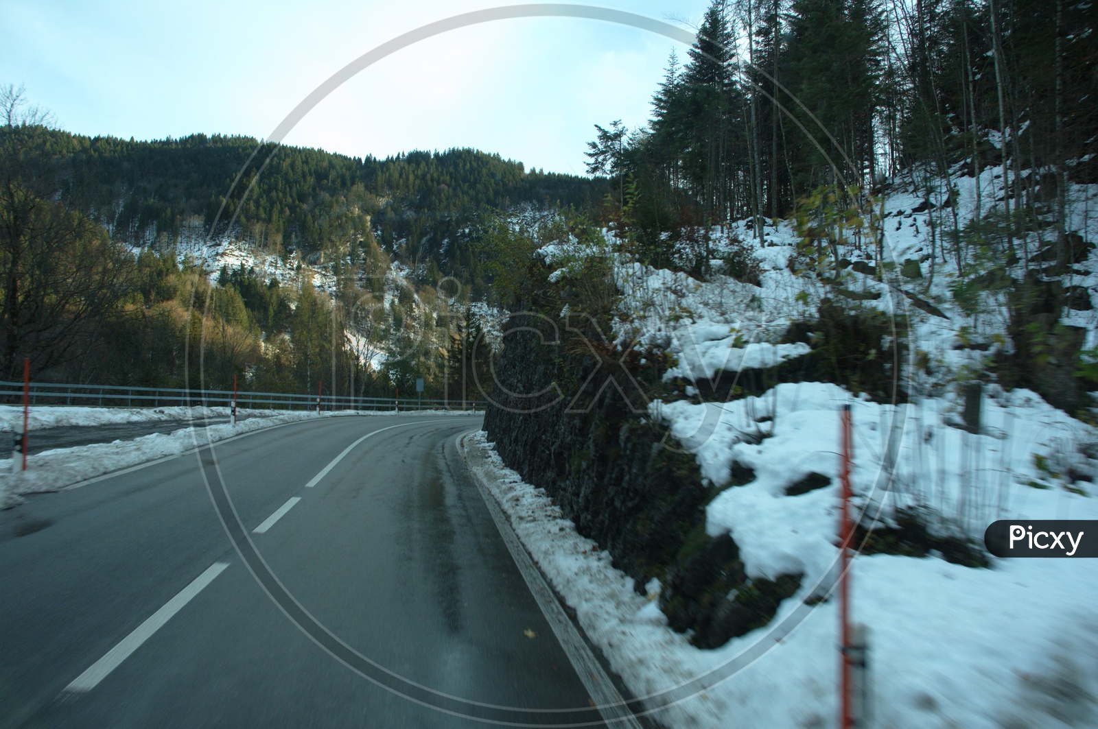 View of roadway alongside the Alpines covered with snow