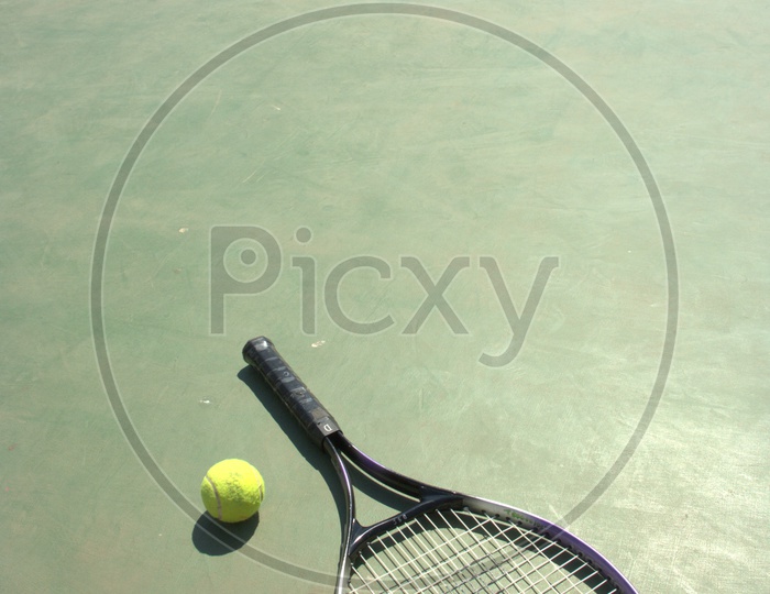 Tennis racket and ball in a court