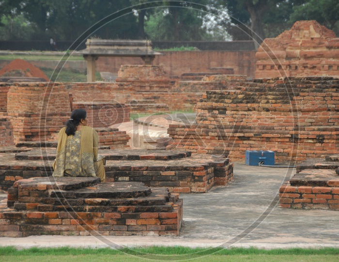 A woman at a Archaeologist site - Ruins