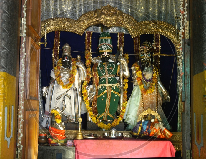Hindu God statues decorated with garlands